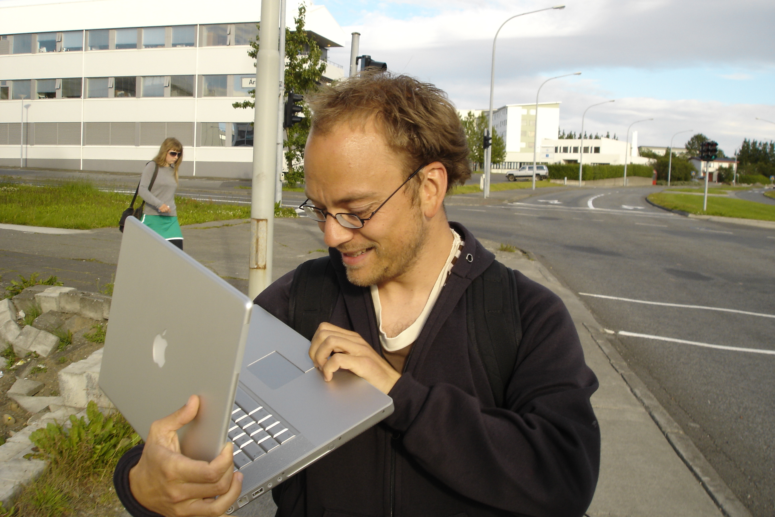 Even Westvang on a Reykjavík street, walking with his 17-inch silver Apple PowerBook G4 open in one hand, looking down at the screen and grinning.